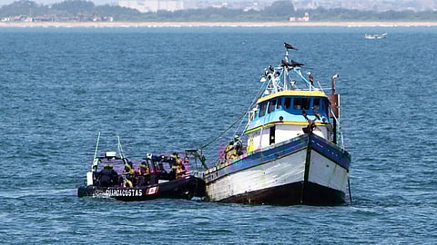Agents of the Peruvian coast guard service inspect a fishing vessel.