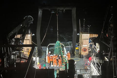 Crew deploying a new trawl net from the back deck of the NOAA Ship Rueben Lasker.