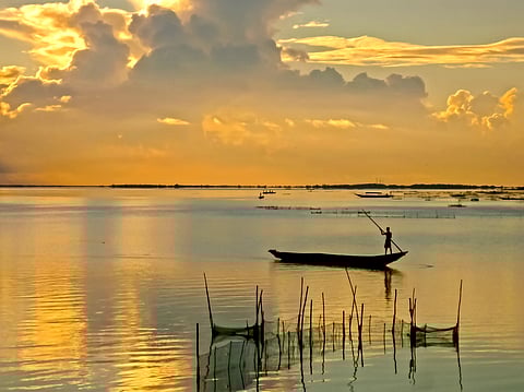 Beautiful sunrise of the Chilika Lake in orange color at Odisha state in India