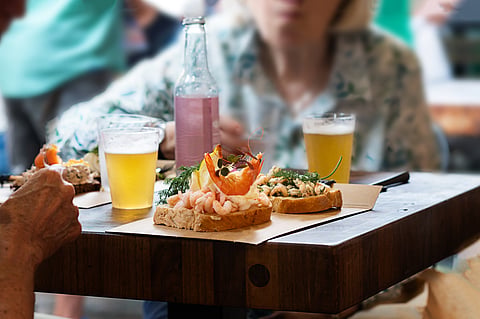 Smorrebrod, Danish open-faced shrimp sandwich on a table in a cafe.
