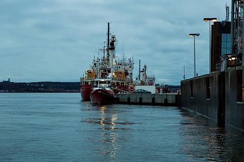 Quebec City, Quebec, Canada, November 2, 2024 - The Fisheries and Oceans Canada boats moored in the old port during a cloudy blue hour fall morning.