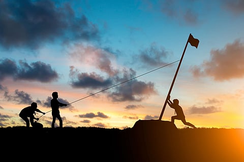 Silhouette team business helps Work together as a team to accomplish your goals to reach the finish line over blurred natural. Motivate employee growth concept.