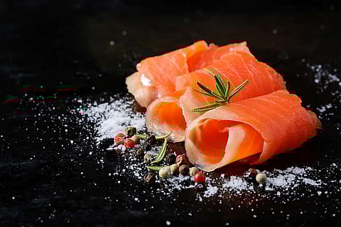 Salted salmon with rosemary and pepper. Selective focus