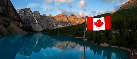 Panoramic view of an Iconic Famous Place, Moraine Lake, during a vibrant summer sunrise. Located in Banff National Park, Alberta, Canada.