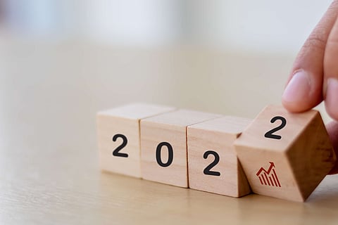 Business growth concept in 2022 for business plan and strategy. Hand flips wooden cubes 2022 and growth trend on beautiful background and copy space. Banner for the new action plan ,annual plan.