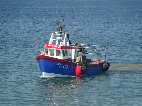 Fishing boat returning with catch near Whitstable, Kent, UK.