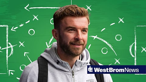 West Brom manager James Morrison in front of a tactics board.