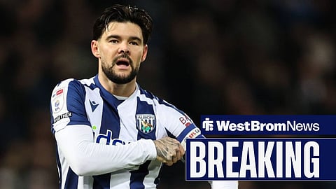 Alex Mowatt holding his captain armband while in action for West Bromwich Albion.