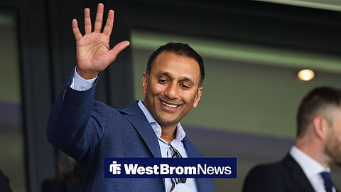 West Brom chairman Shilen Patel looks down below him and waves to Baggies fans from a box at The Hawthorns.