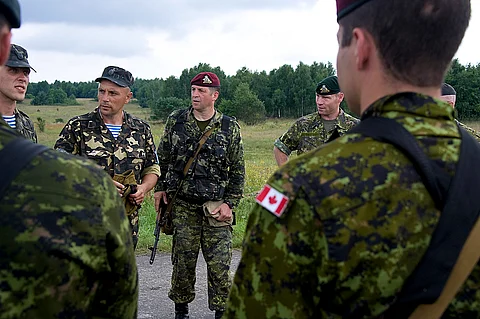 Canadian Armed Forces Col. Victor Kopachinskiy, along with Capt. Robert Colbourne and Lt. Col. Roch Pelletier address C Company after a parachute landing during Exercise Rapid Trident 2011.