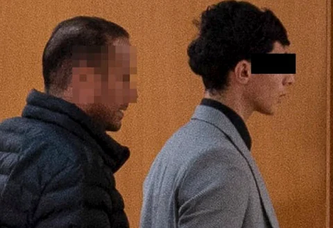 A gang rape (acquitted) suspect is led out of a courtroom in Austria