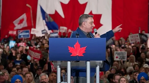 Arnie Stadnick speaking at Pierre Poilievre's rally near Edmonton