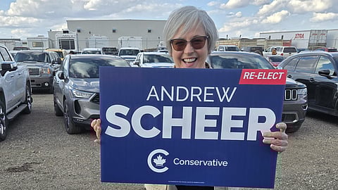 2019 PPC candidate Tracey Sparrowhawk holds the sign of her former Regina-Qu'Appelle opponent Andrew Scheer at a Pierre Poilievre rally in Saskatoon