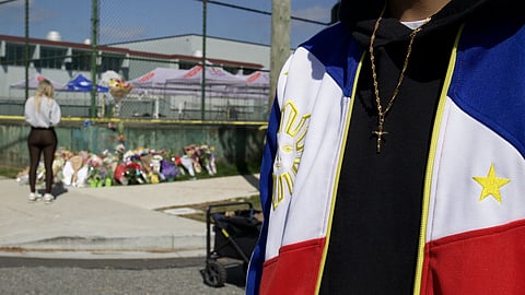 People pay their respects near the scene of the horrific Lapu Lapu Day festival attack in Vancouver
