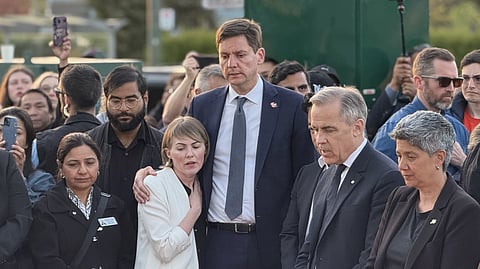 David Eby and his wife stand alongside other leaders and mourners at a memorial for the victims of the Lapu Lapu Day festival attack in Vancouver