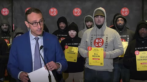 Bolo press conference with cops wearing spoof mugshots of the accused