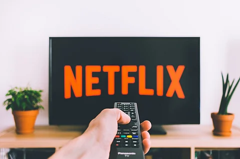 Netflix’s record revenue and price hikes portend an economic crash warns economist.
