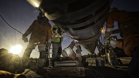 Welding a section of pipeline in Canada