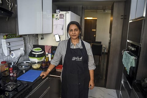 In this photo taken on January 8, 2020, home chef Rashmi Sahijwala, 59, poses for photographs in her kitchen in Mumbai. Rashmi Sahijwala never expected to start working at the age of 59, let alone join India's gig economy - now she is part of an army of h