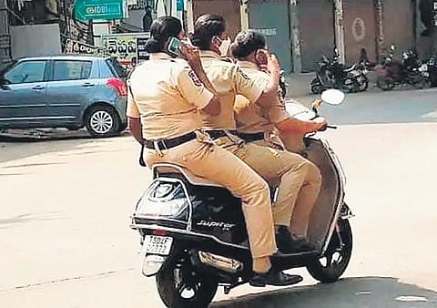 The three woman constables from Khammam who were fined for triple riding on a two-wheeler without helmets