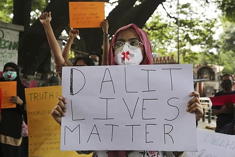 FILE - Demonstrators hold signs during a protest condemning the alleged gang rape and killing of a Dalit woman, in Bengaluru, India, Sunday, Oct. 4, 2020.