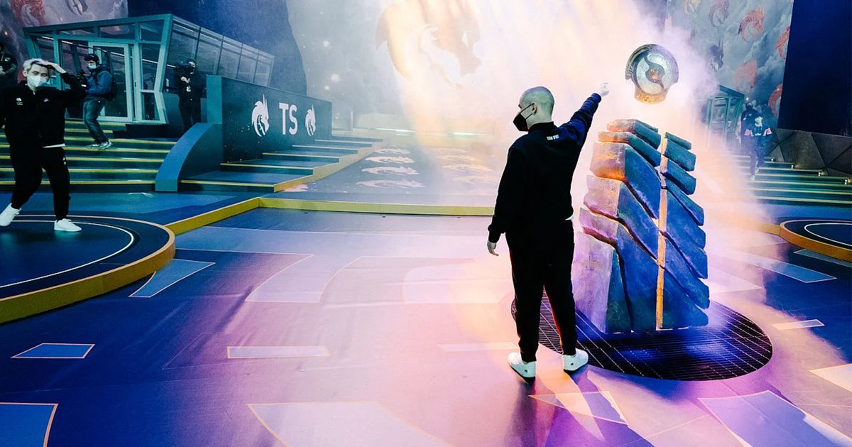 <div class="paragraphs"><p>Yatoro pointing towards the Aegis of Champions after winning TI10</p></div>