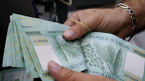A man counts Lebanese pounds at an exchange office in Beirut, Lebanon, August 16, 2018. REUTERS/Mohamed Azakir
