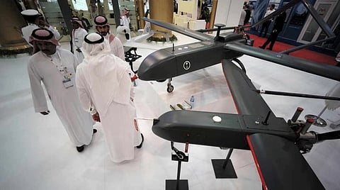 Visitors are seen at Saudi Military Drone manufacturing stand during inauguration of Bahrain International Defense Exhibition and Conference at the Bahrain Exhibition Center (Reuters)
