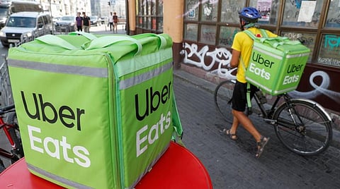 An Uber Eats food delivery courier pulls a bicycle in central Kiev, Ukraine September 9, 2019. REUTERS/Valentyn Ogirenko
