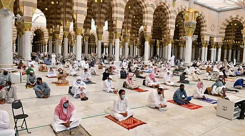 Worshippers observe social distancing measures while performing prayers at the Prophet's Mosque in Madinah. (SPA)
