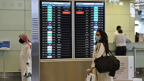 A passenger, wearing a protective face mask, arrives at King Fahad International Airport. (File photo: AFP)
