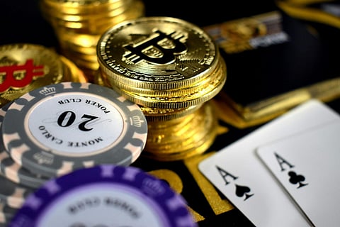 A visual representation of crypto gambling featuring playing cards, Bitcoin coins, and poker chips, symbolizing the rise of the most recommended crypto casinos in Korea, including popular platforms like Royal Korea. 
