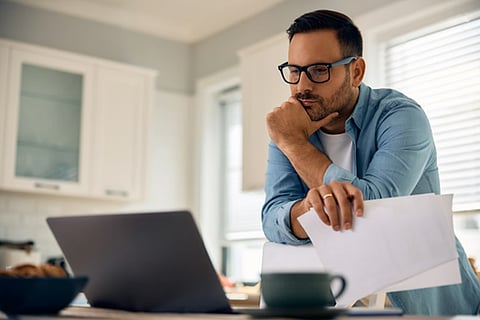 investor reviewing financial documents and considering investment options