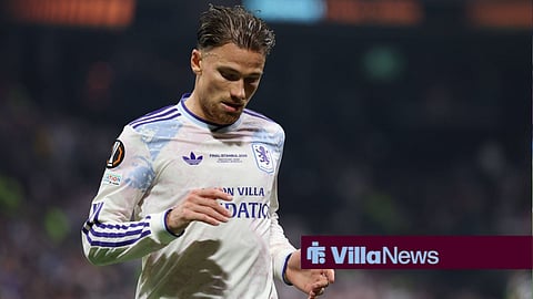 Matty Cash looking down playing for Aston Villa