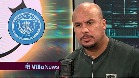 Gabby Agbonlahor speaking on talkSPORT looking at a Manchester City badge