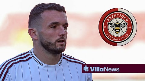 John McGinn pre-match for Aston Villa looking at Brentford badge