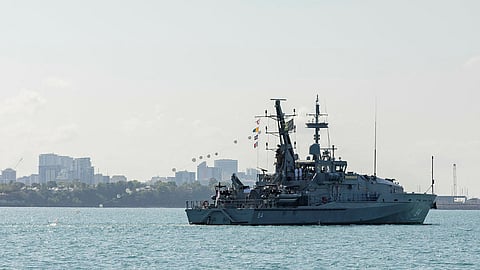 The Royal Australian Navy Armidale-class patrol boat HMAS Larrakia streams her decommissioning pennant while sailing into Darwin Harbour for the final time to berth alongside HMAS Coonawarra in the Northern Territory, September 23, 2023.