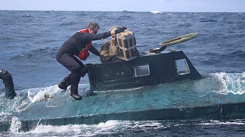 US Coast Guard personnel offload suspected narcotics from a submersible intercepted in international waters of the Pacific Ocean, September 24, 2019.