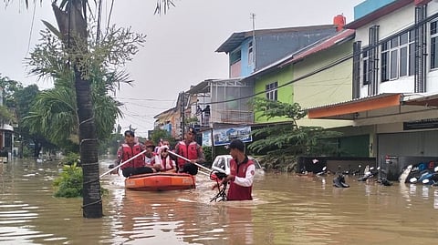 Indonesian police in inflatable boats evacuate citizens in Jakarta following flooding in March 2025
