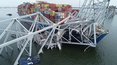 The containership Dali with portions of the collapsed Francis Scott Key Bridge across its forward deck on March 28, 2024