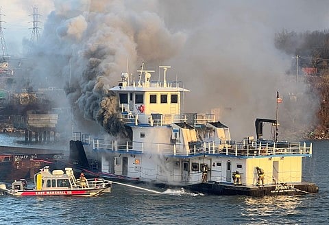 Local firefighters fighting the fire aboard Johnny M