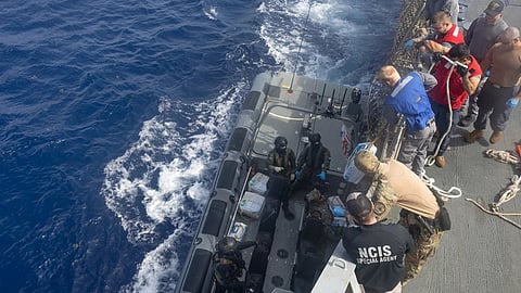 US Coast Guardsmen, Navy Sailors and Naval Criminal Investigative Service aboard the Arleigh Burke-class guided missile destroyer USS Cole  unload contraband from a Fast Raiding Interception and Speacial Forces Craft rigid-hull inflatable boat attached to the Royal Netherlands Navy Holland-class offshore patrol vessel HNLMS Friesland during a contraband transfer in the Caribbean Sea June 17, 2025. 
