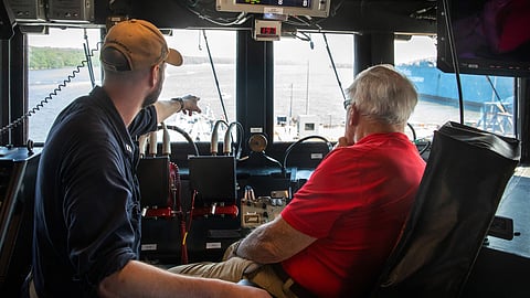 Retired US Marine Corps Colonel Harvey C. Barnum Jr. (right) sits on the bridge of the guided-missile destroyer USS Harvey C. Barnum Jr. during the latter's sea trials off Maine, July 15, 2025.