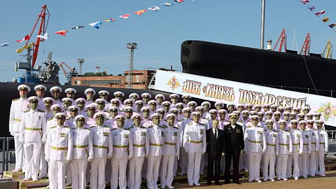 Russian President Vladimir Putin with Russian Navy personnel at the commissioning ceremony of the Project 955A ballistic missile submarine Knyaz Pozharskiy, July 24, 2025
