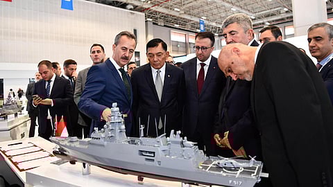 Indonesian and Turkish officials inspecting a scale model of an Istif-class frigate