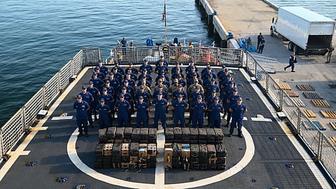 The crew of the US Coast Guard cutter USCGC Tahoma stand at parade rest with seized contraband on the cutter's flight deck at Port Everglades, Florida, July 29, 2025. The seized contraband was the result of an interdiction on June 24, 2025, approximately 120 miles northwest of Ecuador.