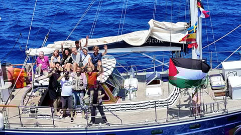 Freedom Flotilla Coalition (FFC) activists aboard the yacht Madleen. The FFC is also part of the larger activist group known as the Global Sumud Flotilla.