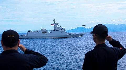 Philippine Coast Guard crew aboard the offshore patrol vessel BRP Gabriela Silang salute the Philippine Navy frigate BRP Diego Silang as the latter transits through the waters off Zambales province, September 8, 2025.