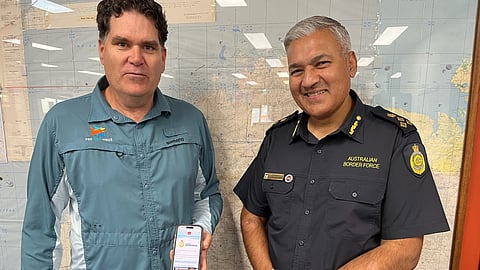 Recfishwest CEO Dr Andrew Rowland and Australian Border Force Commander Ranjeev Maharaj presenting Recfishwest's fishing app, which may now be used to report suspected illegal fishing activities