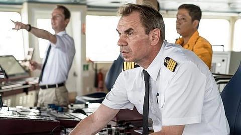 Captain and crew on ship's bridge